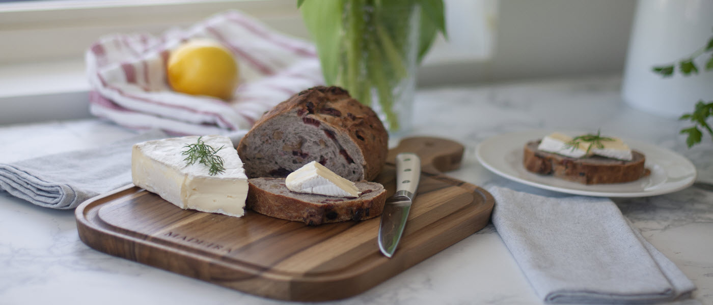 Madeira teak cutting board with bread and brie