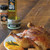 VANILLA MAPLE ROASTED CHICKEN
This vanilla maple roasted chicken brings a twist to a classic Sunday meal. Floral vanilla, sweet maple, and bright orange help bring out the savory and umami flavors of this juicy roast chicken. The perfect recipe for a weekend dinner with family. Bring the flavors of fall alive with this recipe! 

...

Prep Time:  30 minutes  - Cook Time:  60 minutes - Total Time:  90 minutes
Serves: 5-7

...
Ingredients:

 - 4lb Chicken
- 1 Tbsp Rosemary Sea Salt
- 1 Tbsp Maple Orange Sugar Shaker
- 1 Tbsp Vanilla Maple Olive Oil
- 1/4 Yellow Onion
- 1/4 Large Orange
- 3 Sprigs Thyme
- 3 Springs Rosemary

Glaze:
- 1/4 cup Cranberry Spice Balsamic Vinegar
- 1/2 tsp Fresh Rosemary, minced
- 1/2 tsp Fresh Thyme, minced
- 1 tsp Maple Orange Sugar Shaker

 ...

Instructions:

Preheat oven to 450F. 
In a small saucepan combine ingredients for the glaze and cook over medium heat for about 5-7 minutes to let the flavors infuse. Set aside.
Pat chicken dry and season the chicken all over with salt, shaker, and olive oil. Make sure to use your hands to gently loosen the breast skin and season the meat under the skin as well as inside the cavity. 
Stuff cavity with onion, orange, thyme, and rosemary. Place chicken in a dutch oven or roasting rack breast side up. And cook at 450F uncovered for 20 minutes to obtain color on the skin. 
Remove chicken from oven and reduce the temp to 350 F. Meanwhile brush the skin with a layer of glaze. Reserving glaze foer. 
Place the chicken in the oven at cook for 20 minutes uncovered for every 1lb. If skin starts to darken to much cover with lid or foil. 
Every 15 minutes remove the chicken from the oven to reapply the glaze until its gone. 
Remove the chicken from the oven when the thigh registers 155F and let rest until the internal temperature reachs 165F. About 15 minutes. 
Serve chicken with your favorite sides and enjoy!