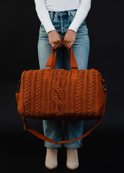 Rust cable knit duffel bag