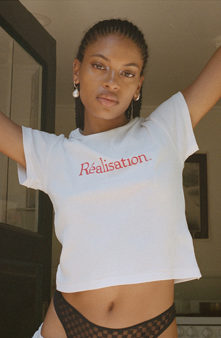 Realisation Logo Tee, White Baby Tee with Red Logo