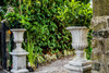 Pair of Large Stone Cast Flute Urns and Classic Plinths