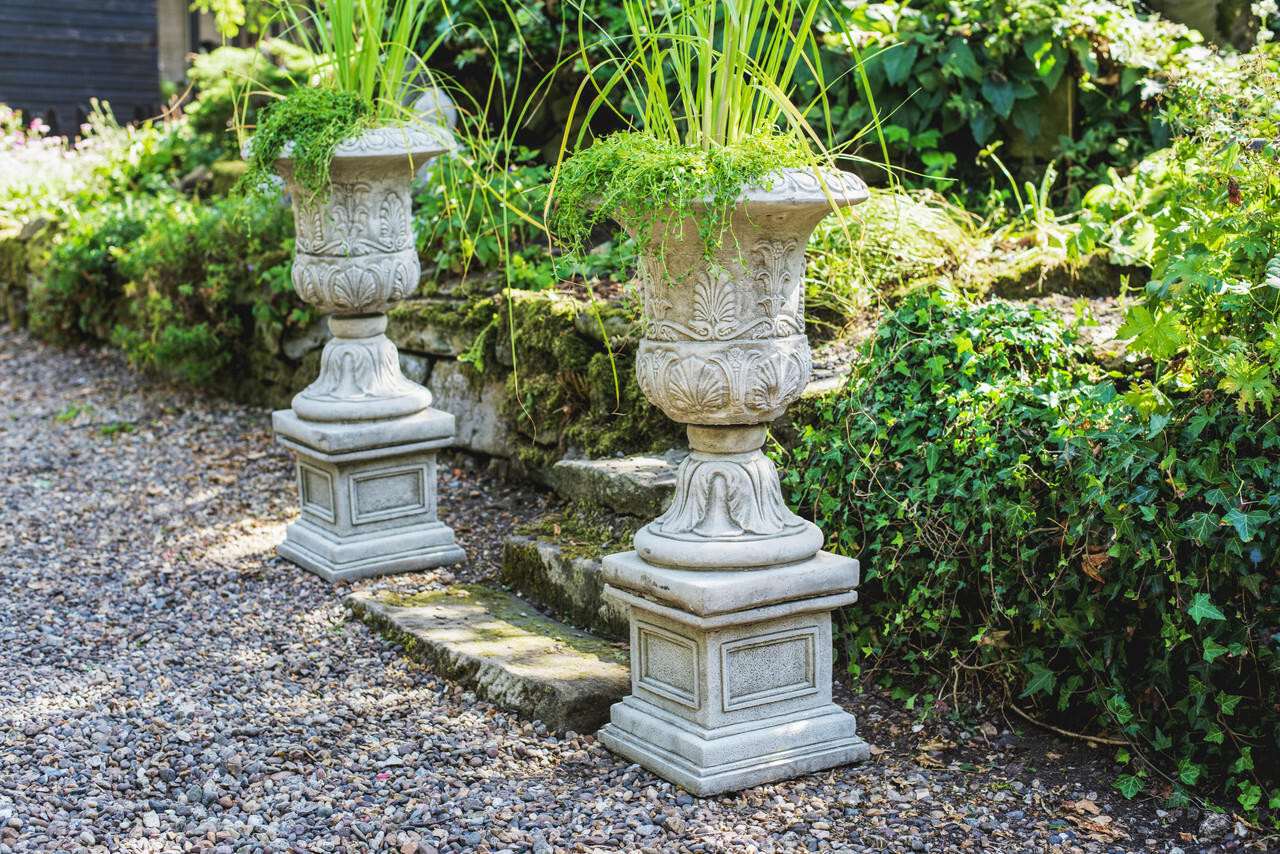 Pair of Large Victorian Stone Cast Urns with Plinths