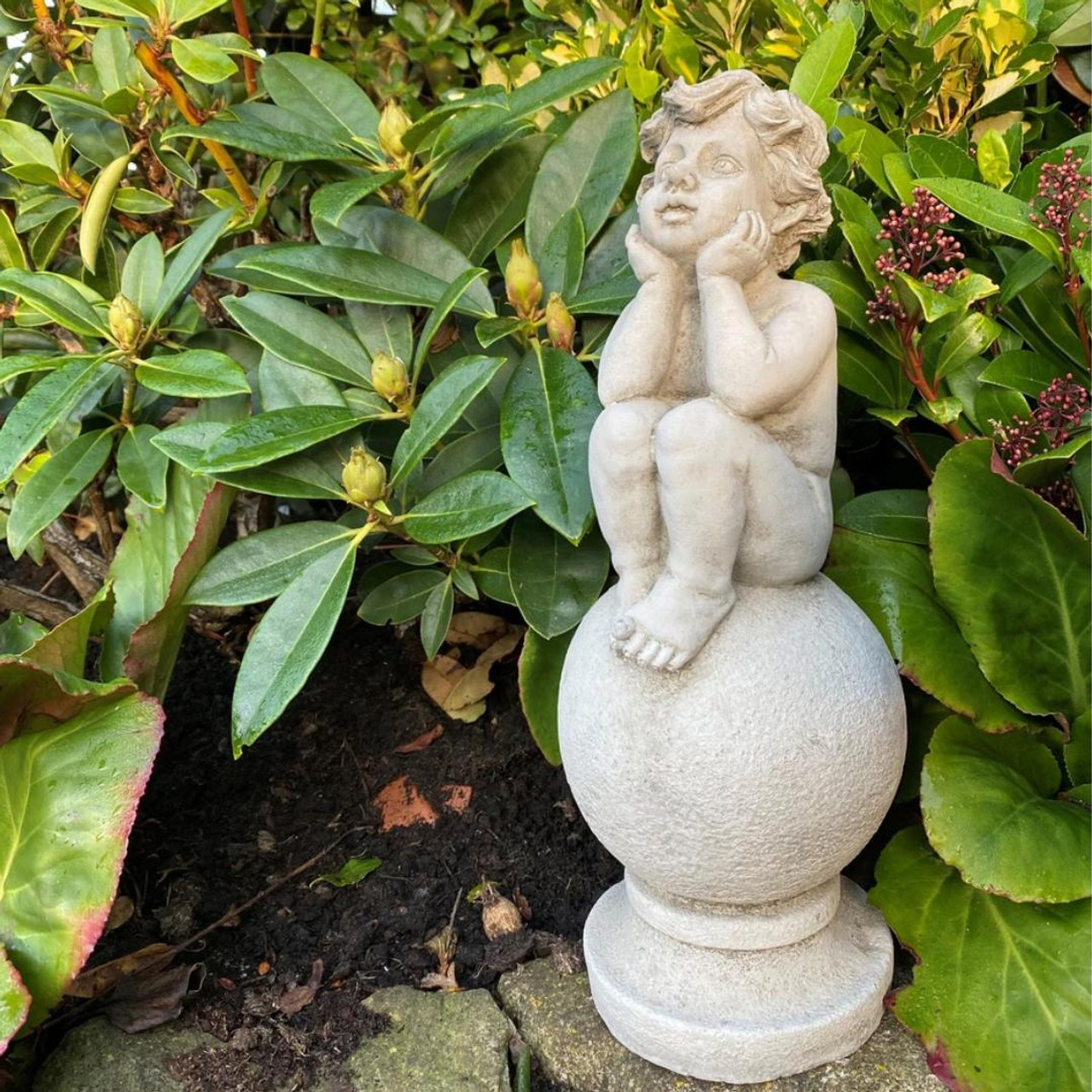 Adorable Stone Cast Boy on Ball Statue