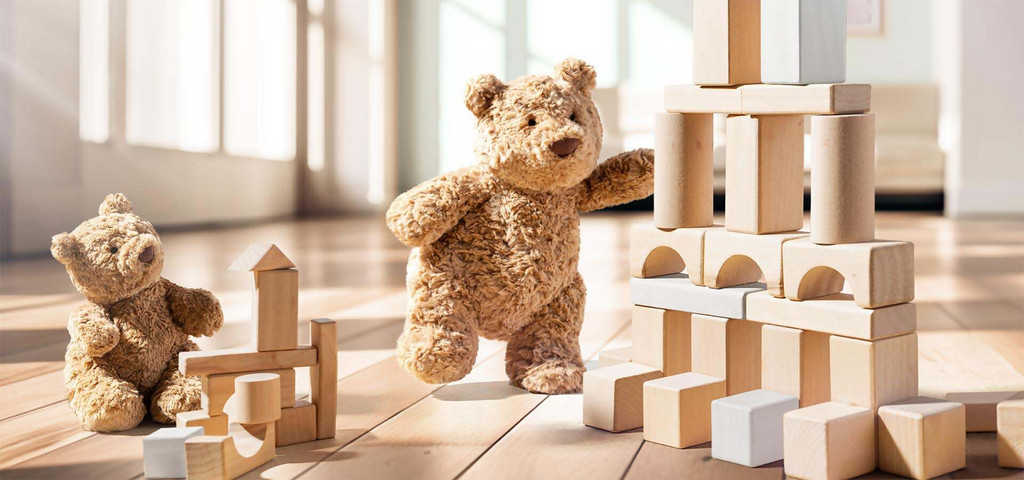 Barhtolomew bear baby playing with blocks