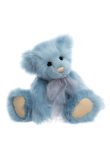 A blue fluffy Charlie Bears teddy bear sits upright against a white background, wearing a sheer grey ribbon bow at its neck, with cream-coloured paw pads and a tan nose.