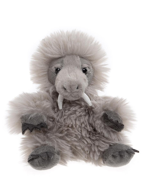 A grey fluffy woolly mammoth plush toy sits upright against a white background, featuring a shaggy mane, small white tusks, and dark clawed feet and hands.