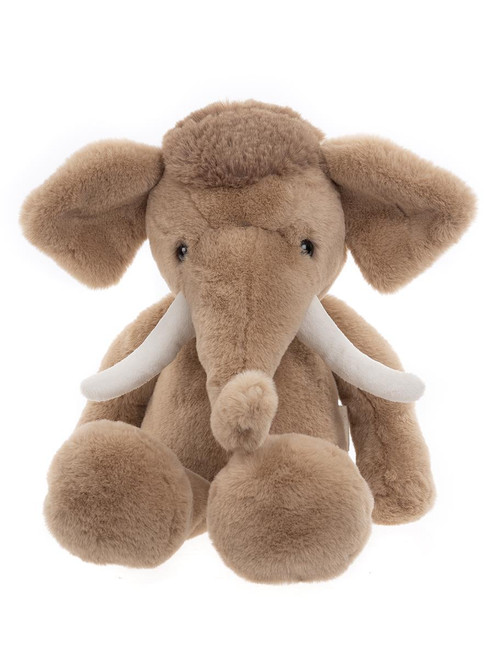 A tan plush mammoth stuffed animal sits upright against a white background, featuring large floppy ears, white curved tusks, and a short trunk.