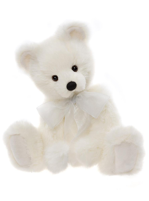 A white plush teddy bear sits upright against a white background, wearing a sheer white organza ribbon bow tied around its neck.