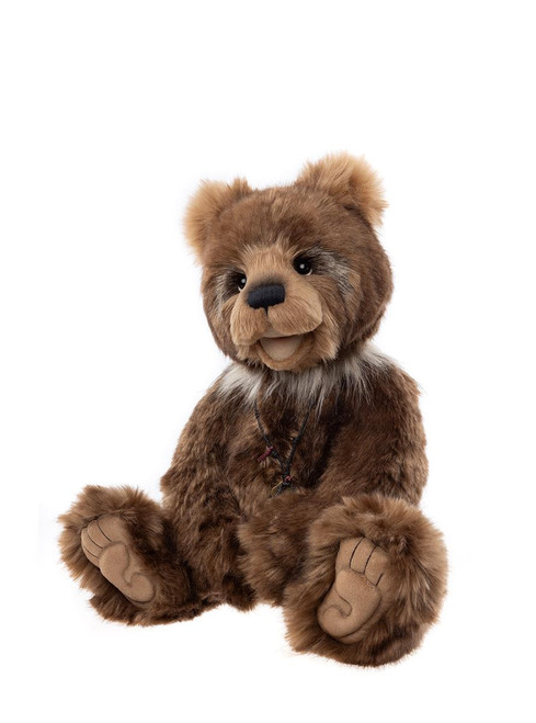 A highly realistic brown plush teddy bear with detailed facial features, wearing a small necklace, sits upright against a plain white background.