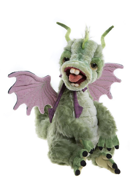 A green plush dragon teddy bear sits upright with its mouth open, displaying pink wings, curved horns, black claws, and a purple bow tie, against a white background.