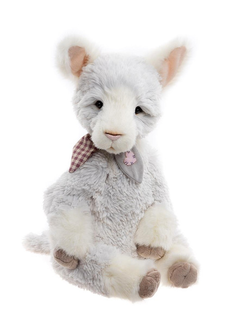 A plush goat teddy bear sits upright against a white background, featuring soft grey-white fur, pink-lined ears, taupe hooves, and a decorative gingham and grey collar with a small flower embellishment.