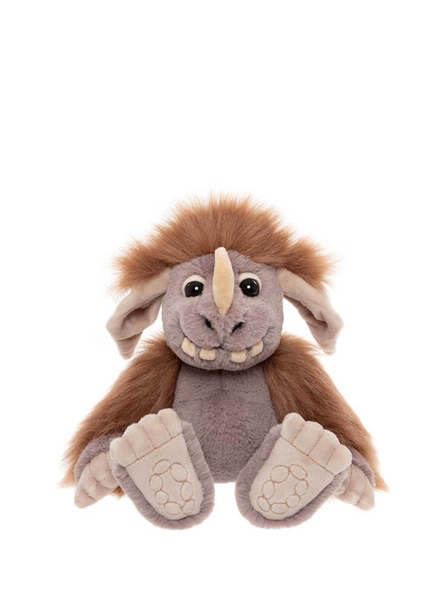 A Charlie Bears plush troll toy sits upright against a white background. It features brown furry hair, grey body, a large nose, grinning teeth, floppy ears, and oversized paw-print feet.