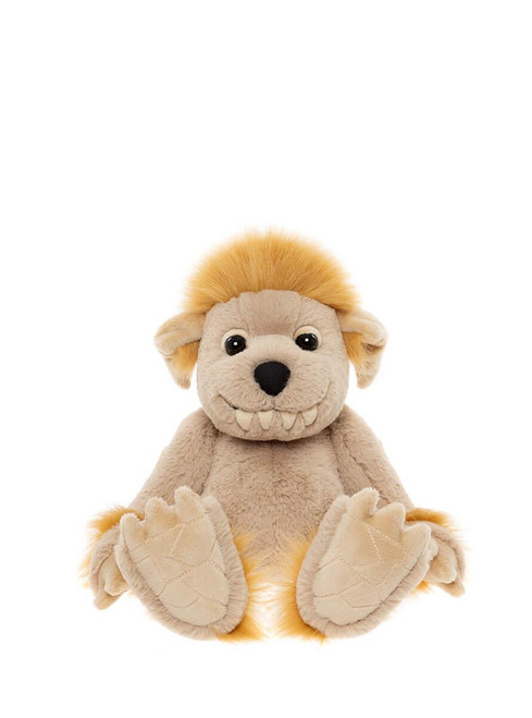 A beige plush monster-like teddy bear with golden hair and fur trim, large clawed feet, and a toothy grin, sits upright against a white background.