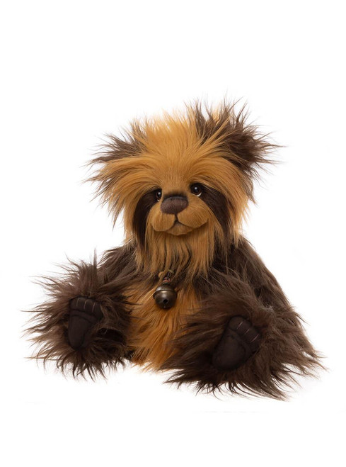A shaggy, dark brown and golden teddy bear with wild fur, small bell pendant, and large paws, sitting upright against a white background.