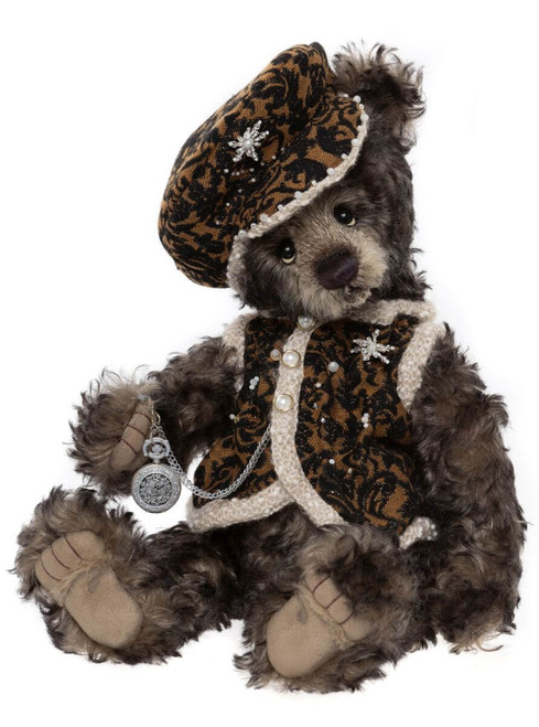 A Charlie Bears teddy bear sits upright, dressed in a baroque-patterned black and gold jacket and matching hat, trimmed with pearls and snowflake jewels, holding a silver pocket watch.