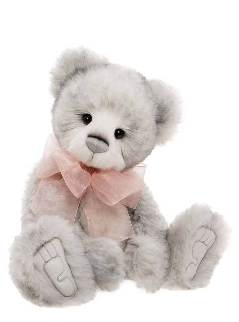 A grey plush teddy bear sits upright against a white background, wearing a sheer pink ribbon bow at its neck, with embroidered toe details on its paws.