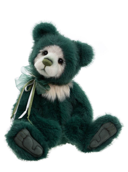 A dark green plush Charlie Bear with cream facial and chest accents, sits upright against a white background, adorned with a green organza and satin ribbon bow at its neck.
