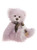 A fluffy lavender-pink Charlie Bear teddy sits upright against a white background, wearing a plaid brown and beige scarf with fringe tassels around its neck.