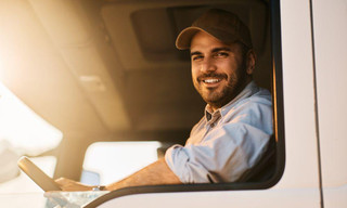 Truck Driver Looking Out the Cab Window Sitting with Proper Posture