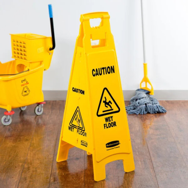 FG611477YEL - Rubbermaid 4-Sided "Caution" Safety Sign - 96.5cm - Yellow - Situated in a Room
