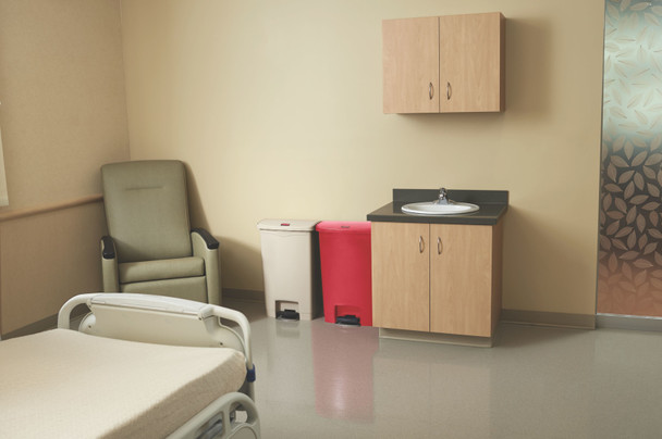 1883566 - A red and beige Rubbermaid Slim Jim Front Step Pedal Bin situated together in a hospital patient's room