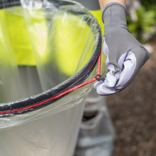 A User Wearing Gloves & Hi-Vis Vest Pulls at Bungee Cord