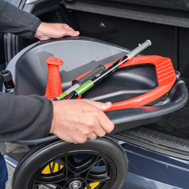 The Handicart Lite in its collapsed configuration being placed into the boot of a car
