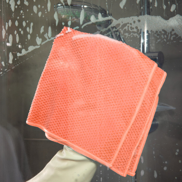Spontex Red MF Pro Recycled Microfibre Cloth Being used to Clean a Shower Screen