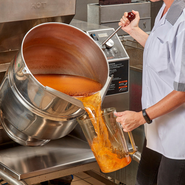3.8L Cambro High Heat Measuring Jug Being Filled with Cooking Waste from a Large Cooking Pan
