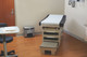 1901982 - A stainless steel Rubbermaid Slim Jim Front Step Pedal Bin situated in a medical examination room