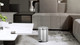 EK9115MT5 - EKO Eva Round Bathroom Pedal Bin - 5 Ltr - Stainless Steel - Situated by a Coffee Table
