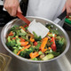 FG1963000000 - Rubbermaid Hi-Heat Scraper - 34cm - Red - Chef Stirring Vegetables in a Pan
