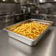 Pujadas 65mm GN 1/1 Pan Positioned on Worksurface and Filled with Chips