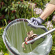 Close-Up of Paper Being Dropped in a Liner Attached to Handi-Hoop