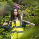 A Female Wearing a Hi-Vis Vest at the Start of Putting Folding Litter Picker Pro into Extended Set-up