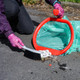A hand-hoop user utilises the innovative rim to sweep waste into the bag