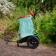 Handicart Lite situated on a wood bark pathway and fitted with a green bin bag