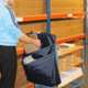 Racksack 2-Pocket Reusable Recycling Sack Hung from the Handle of a Trolley in a Warehouse Setting