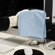 Spontex Blue MF Pro Recycled Microfibre Cloth Being Held by a Gloved User Over a Desk with Monitor, Mouse, Mouse Mat and Keyboard