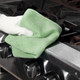 Spontex Green MF Pro Recycled Microfibre Cloth Being used to Clean the Edge of a Cooker