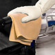 Spontex Yellow MF Pro Recycled Microfibre Cloth Being used to Clean the Arm of a Wheelchair