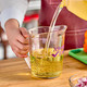User filling a 1 litre Cambro Allergen-Safe Measuring Jug with oil in a commercial kitchen