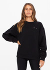 THE UPSIDE women's black Saturn Arrow Sweater is an organic cotton fleece jumper with a relaxed, oversized fit. It features a soft rib at the neckline, handcuffs and cuffs.