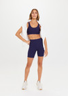 THE UPSIDE women's navy blue Peached Jade Bra is a sustainable scoop neck, full coverage T-back bra with internal elastic in the underbust and removable cups.