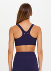 THE UPSIDE women's navy blue Peached Jade Bra is a sustainable scoop neck, full coverage T-back bra with internal elastic in the underbust and removable cups.