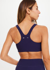 THE UPSIDE women's navy blue Peached Jade Bra is a sustainable scoop neck, full coverage T-back bra with internal elastic in the underbust and removable cups.