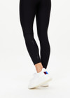 THE UPSIDE women's black Matte Tech 25inch Midi Pant is a mid rise, 7/8 length, matte tech performance legging is made from breathable, quick drying and moisture wicking fabric.