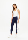 THE UPSIDE women's creme Onyx Kori Crop, made with Recycled Peached fabric is designed for a full coverage fit. This scoop neck top features an internal shelf bra ideal for yoga.