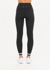 THE UPSIDE women's black mid-rise 25inch legging is made from our form seamless fabric with moisture control properties. It features a soft ribbed waistband and white stripe.