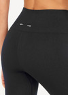 THE UPSIDE women's black mid-rise 25inch legging is made from our form seamless fabric with moisture control properties. It features a soft ribbed waistband and white stripe.